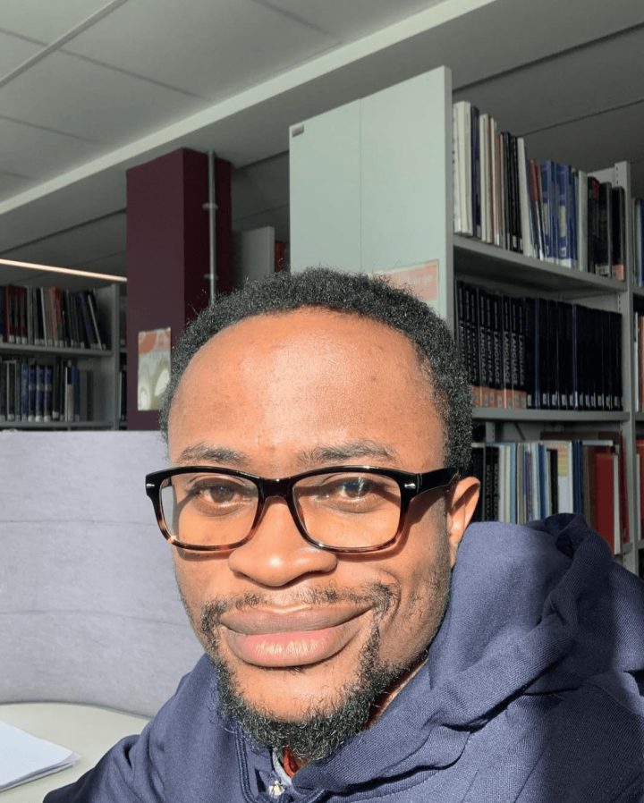Feranmi Adeoye in a library